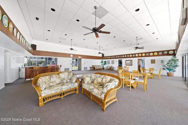 a spacious bedroom with a bed and a chandelier