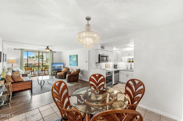 a view of a dining room with furniture and a chandelier