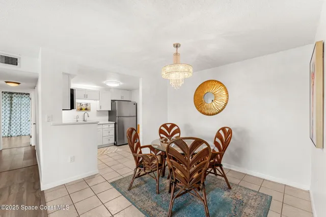 a view of a dining room that has a table and a chair in it