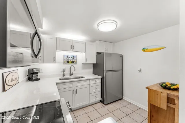 a kitchen with a sink a refrigerator and washer