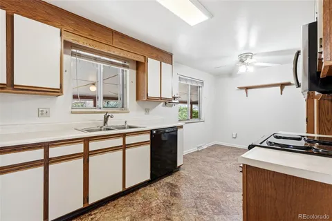 a kitchen with a refrigerator sink stove and oven