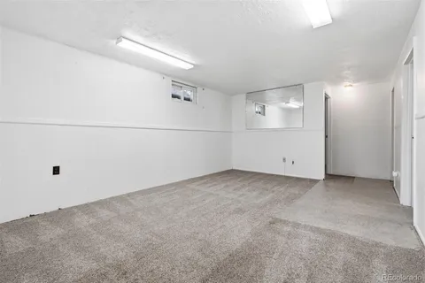 an empty room with wooden floor and closet