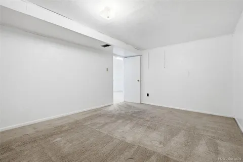 a view of a storage & utility room with refrigerator