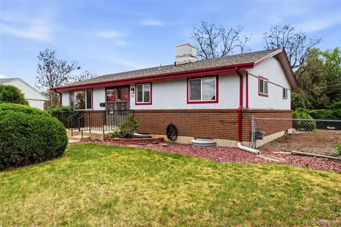a view of a house with a backyard and a tree