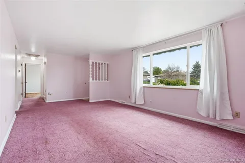 an empty room with large window