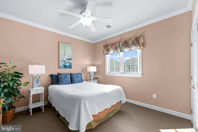 a bedroom with two beds and painting on the wall