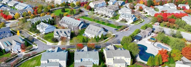 an aerial view of a house with a yard and garden