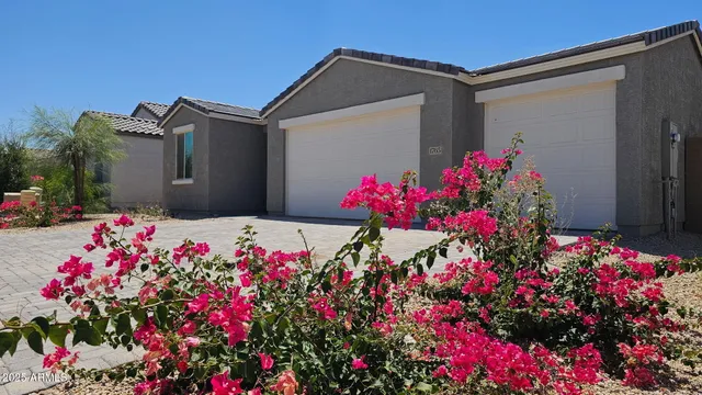 a view of a flower arrangement in front of a house