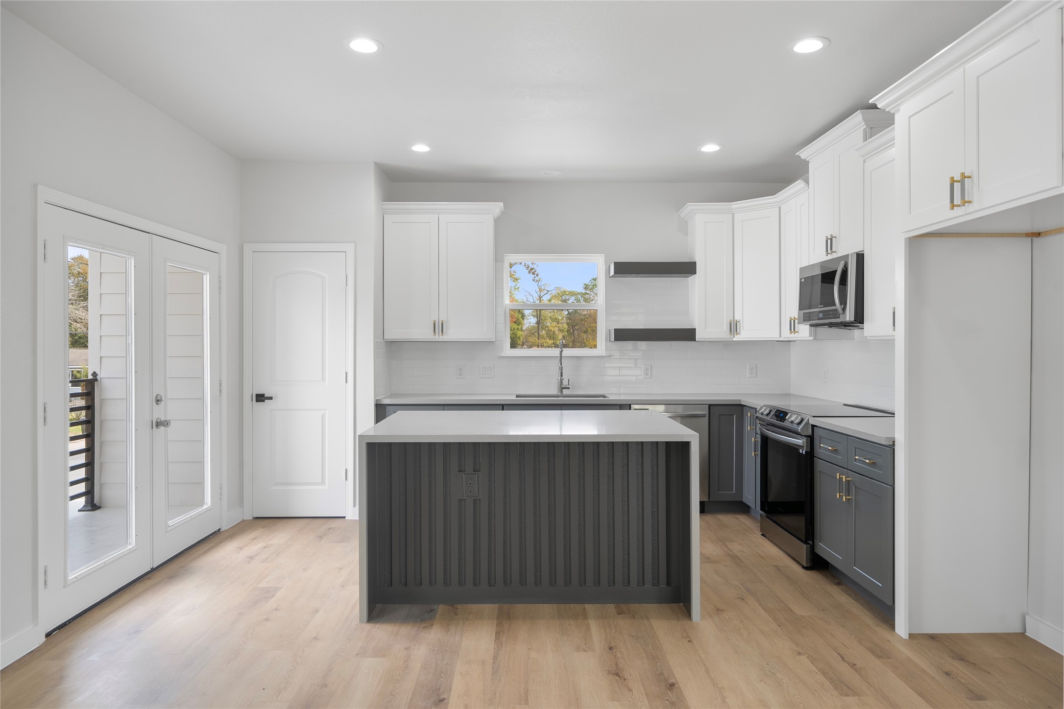 7220 South Hall Street, Unit B Houston, TX 77028 - Photo 12 of 34 a kitchen with stainless steel appliances granite countertop a stove top oven a sink and a refrigerator