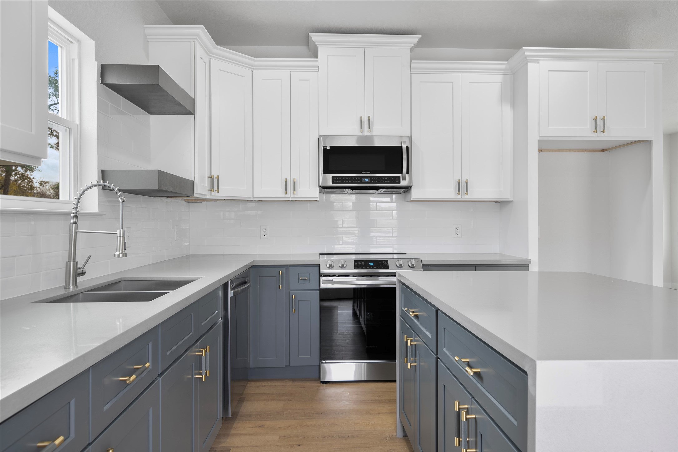7220 South Hall Street, Unit B Houston, TX 77028 - Photo 15 of 34 a kitchen with stainless steel appliances granite countertop a sink stove and microwave