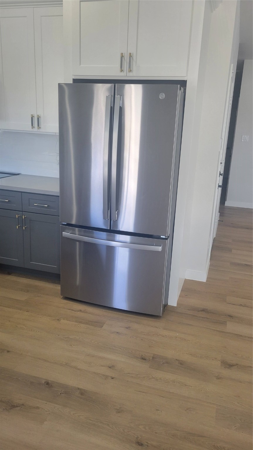 7220 South Hall Street, Unit B Houston, TX 77028 - Photo 29 of 34 a view of a refrigerator in kitchen and white cabinets