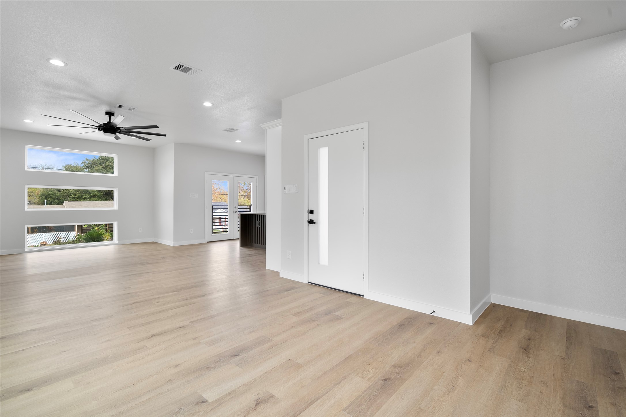 7220 South Hall Street, Unit B Houston, TX 77028 - Photo 7 of 34 wooden floor in an empty room with a window