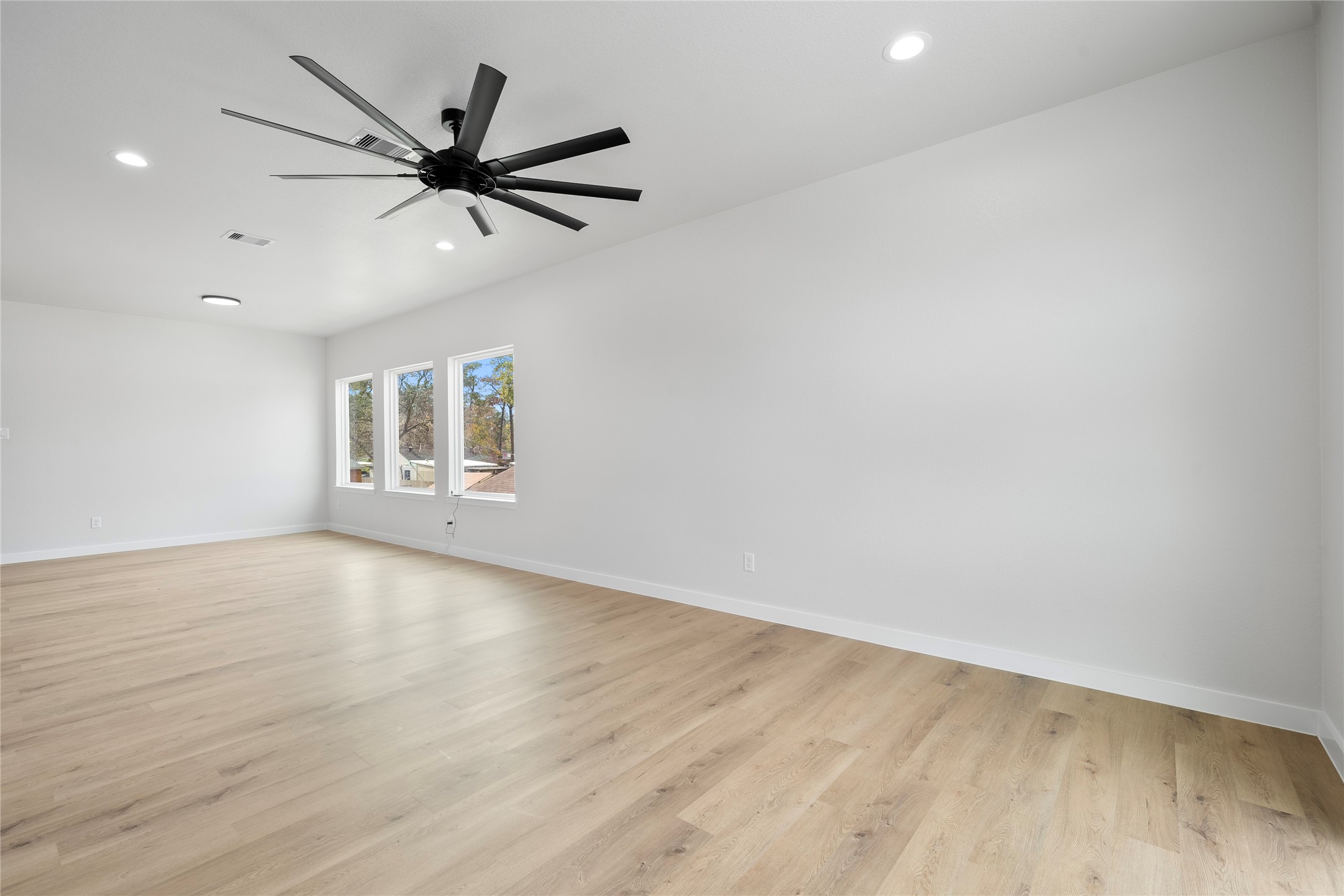 7220 South Hall Street, Unit B Houston, TX 77028 - Photo 8 of 34 wooden floor in an empty room with a window