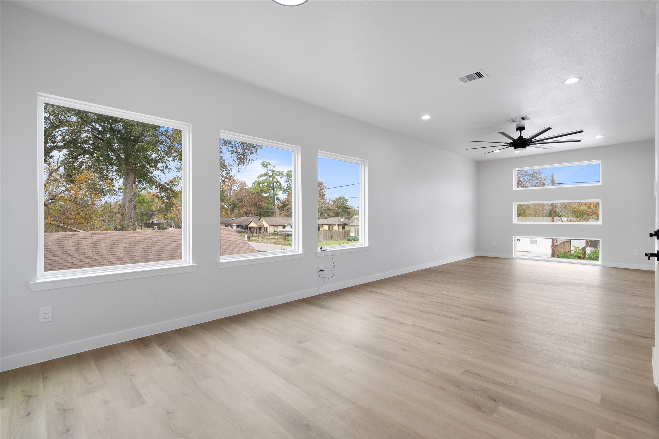 7220 South Hall Street, Unit B Houston, TX 77028 - Photo 9 of 34 a view of an empty room with a window and wooden floor