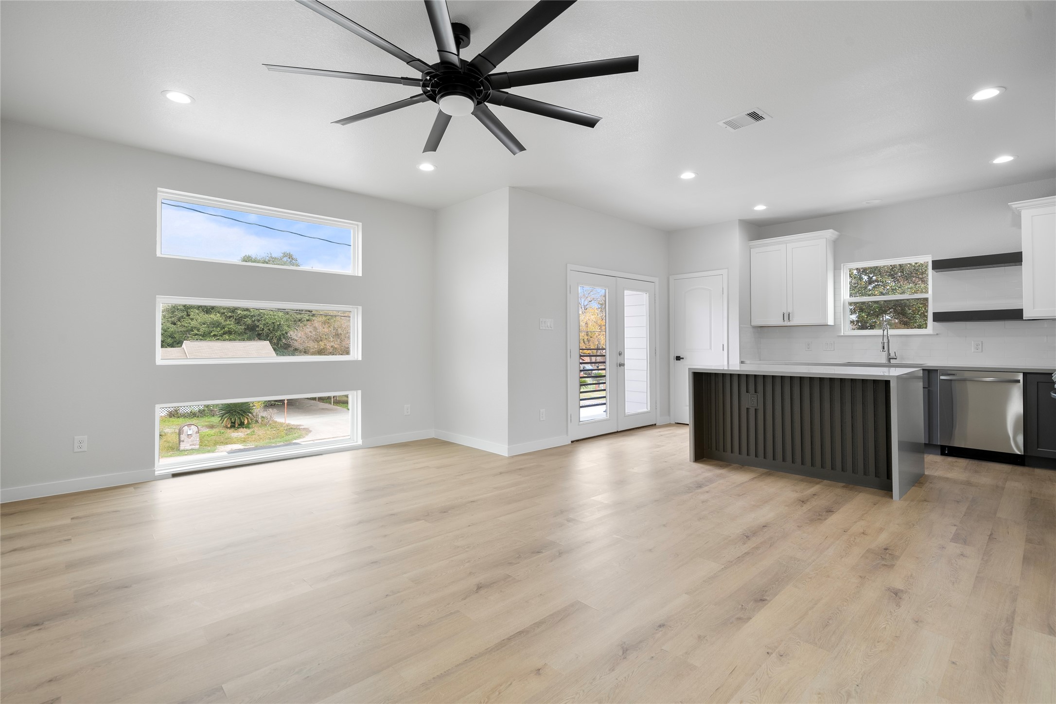 7220 South Hall Street, Unit B Houston, TX 77028 - Photo 10 of 34 a living room with stainless steel appliances kitchen island granite countertop a refrigerator a oven a sink with wooden floors and cabinets