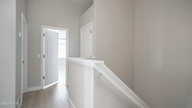 a view of hallway with wooden floor