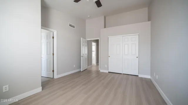a view of an empty room with wooden floor