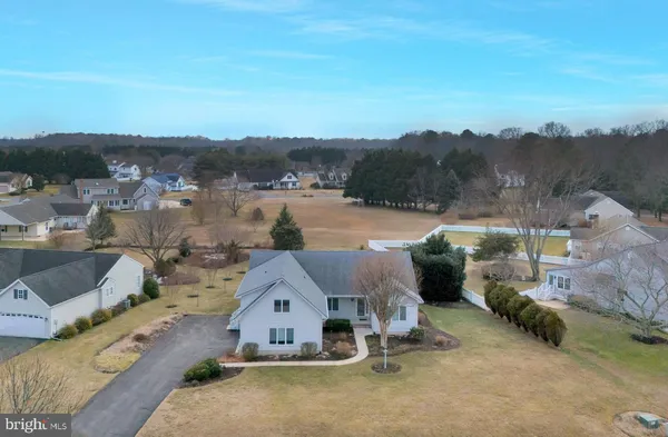 an aerial view of a house with a garden and mountain view