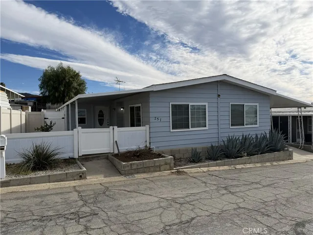 a view of a white house with a yard