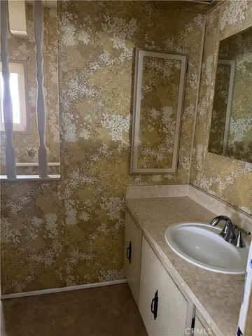 a bathroom with a sink and a mirror