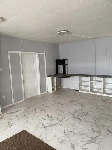 a view of a kitchen with a sink and a refrigerator