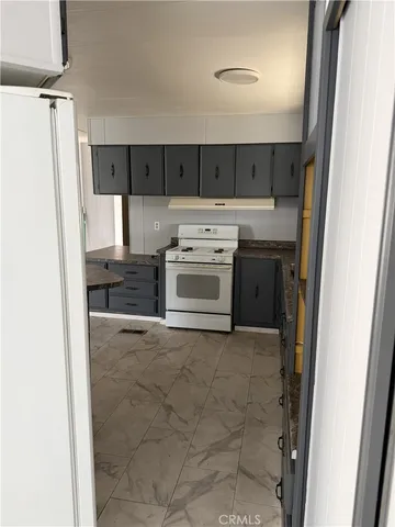 a kitchen with a stove a refrigerator and a sink