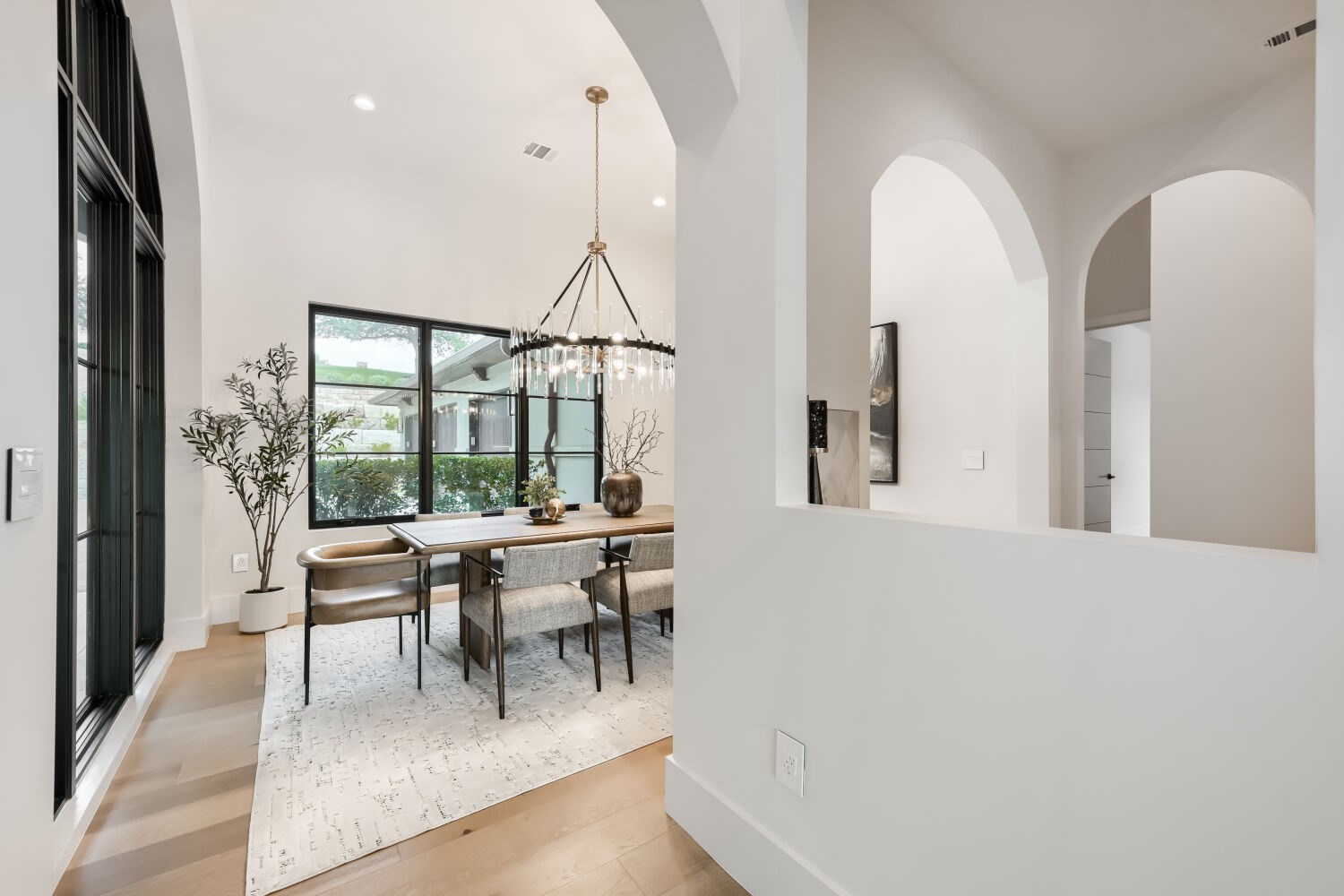8132 Magnolia Ridge Cove Austin, TX 78738 - Photo 18 of 38 A graceful dining area, naturally illuminated by expansive windows, offers an elegant setting for meals.