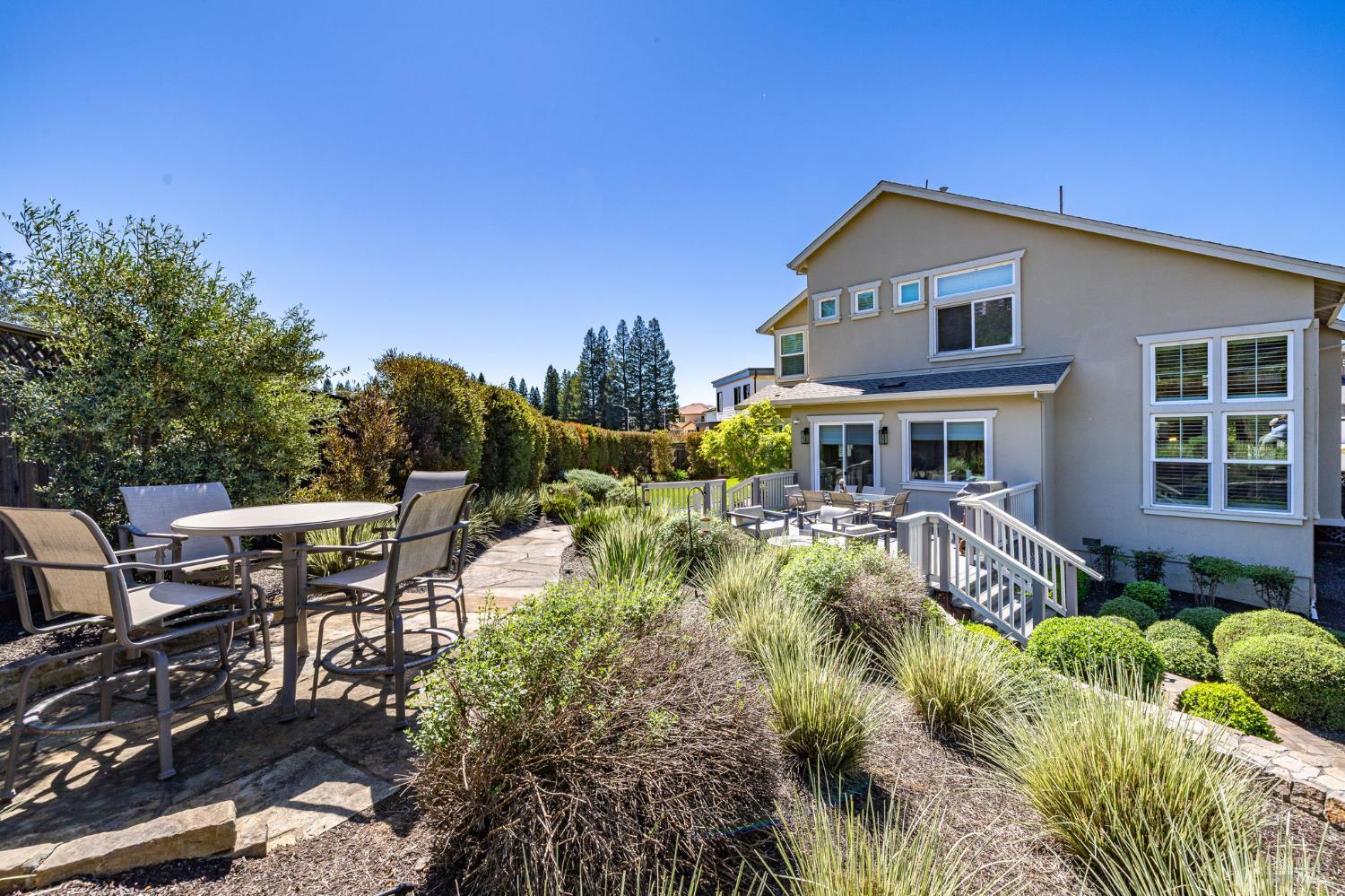 3726 Cannes Place Santa Rosa, CA 95403 - Photo 25 of 69 Looking back at your new home, we have extra seating area to the left front, slate walkways that lead to a level yard with grass to the far left, attached deck for entertaining and to the right (not in the photo) an area with a raised garden bed.