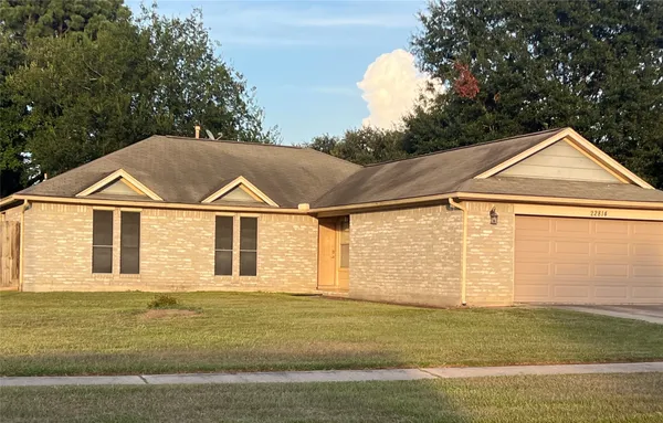 a view of a big house with a yard