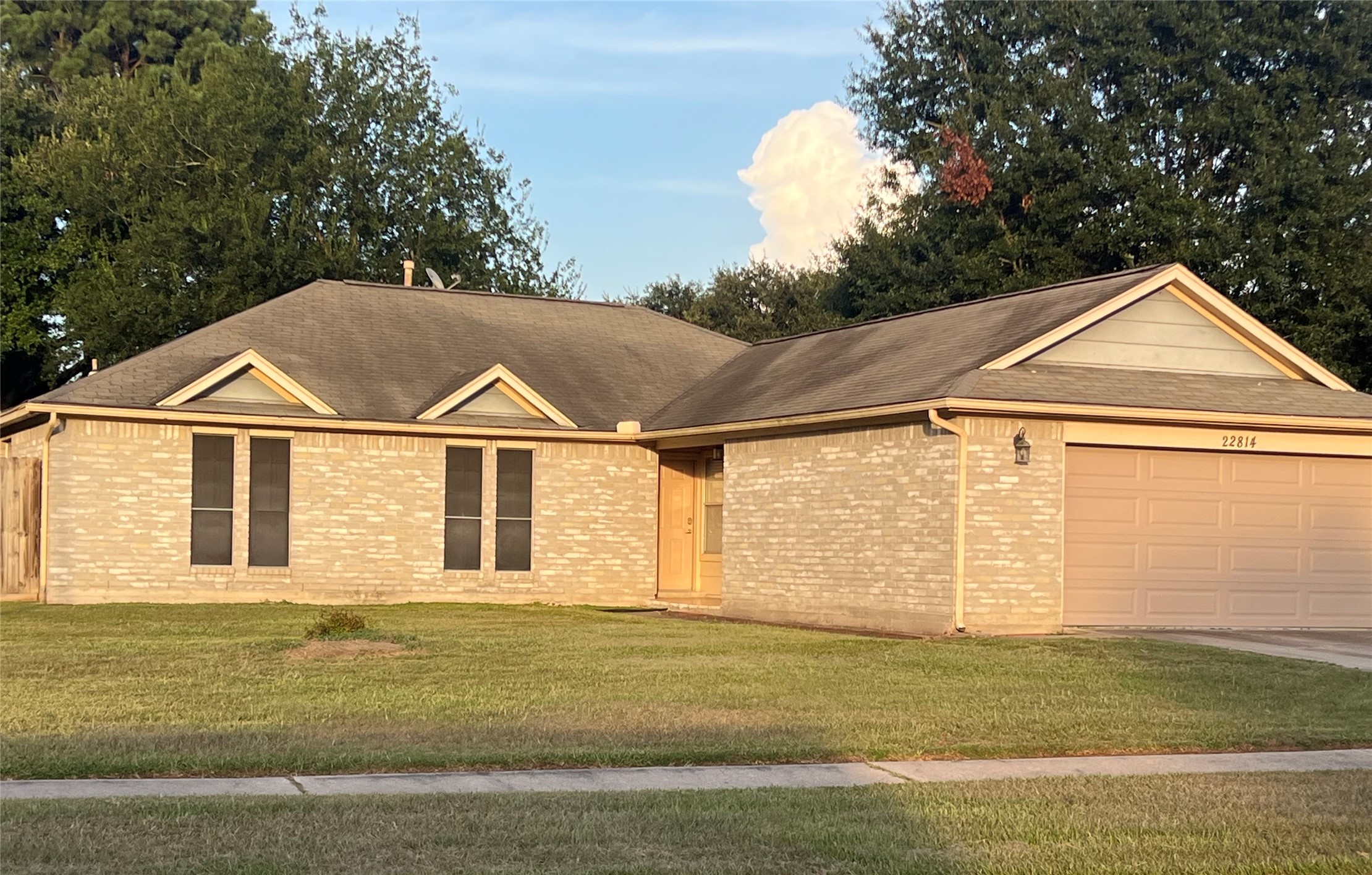 a view of a big house with a yard