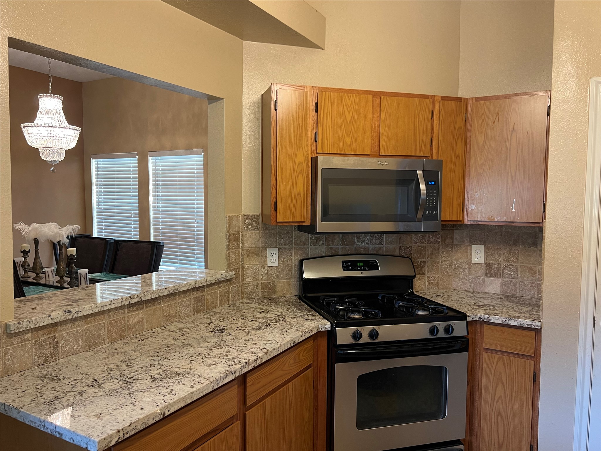 22814 Tree House Lane Spring, TX 77373 - Photo 4 of 11 a kitchen with stainless steel appliances wooden cabinets and a stove top oven