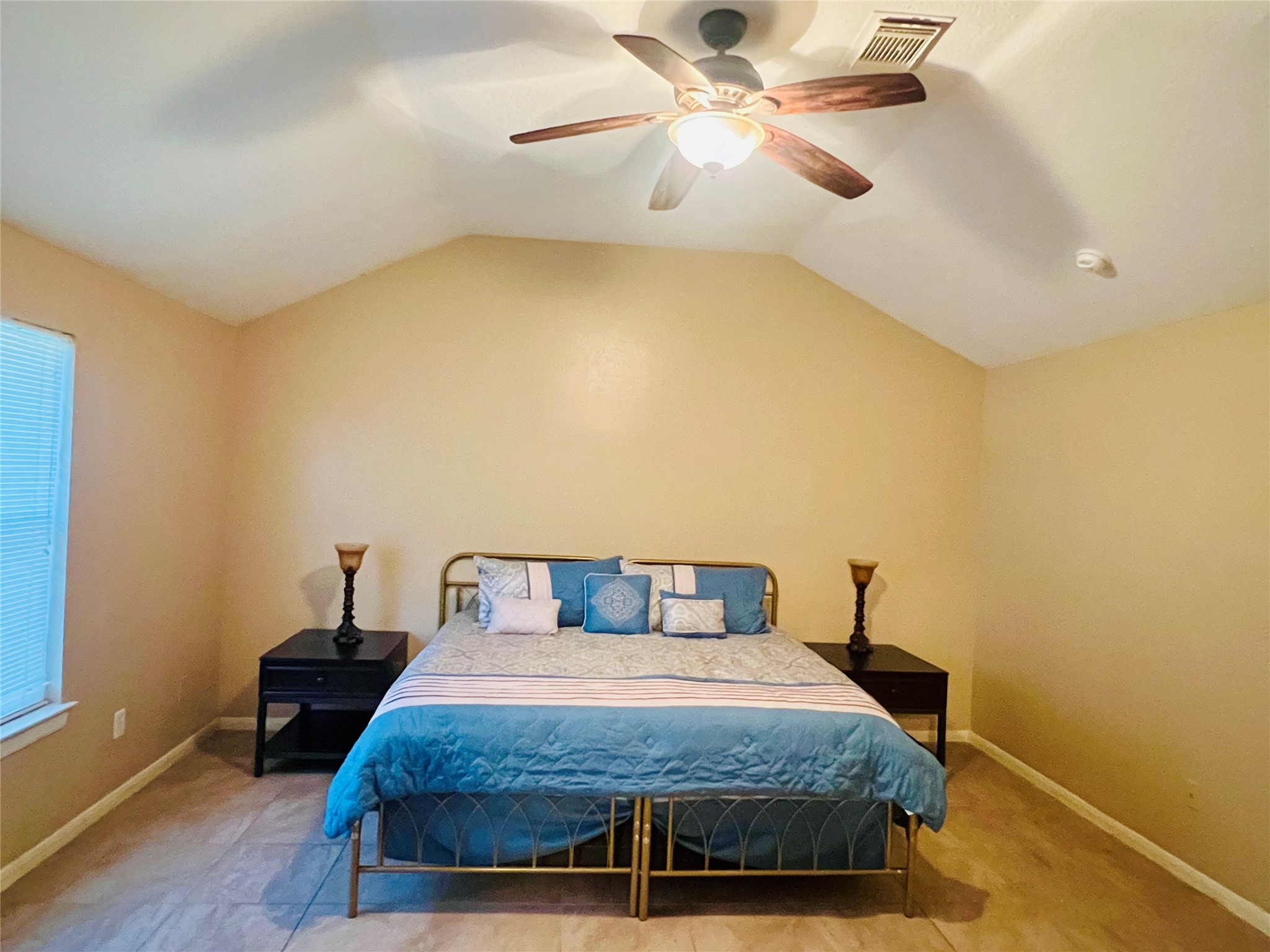 22814 Tree House Lane Spring, TX 77373 - Photo 6 of 11 a bedroom with a bed and a chandelier