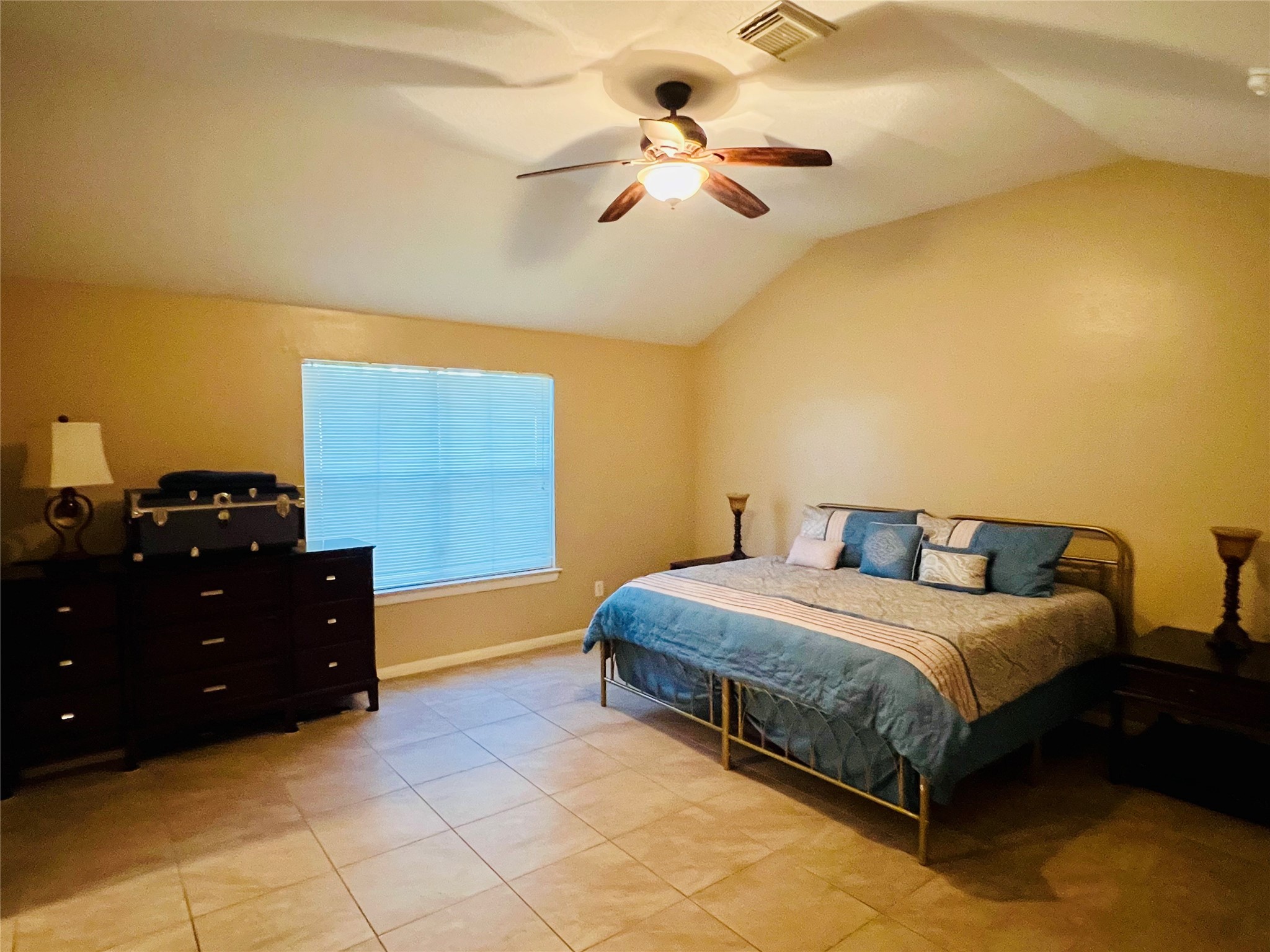 22814 Tree House Lane Spring, TX 77373 - Photo 7 of 11 a bedroom with a bed and a chandelier