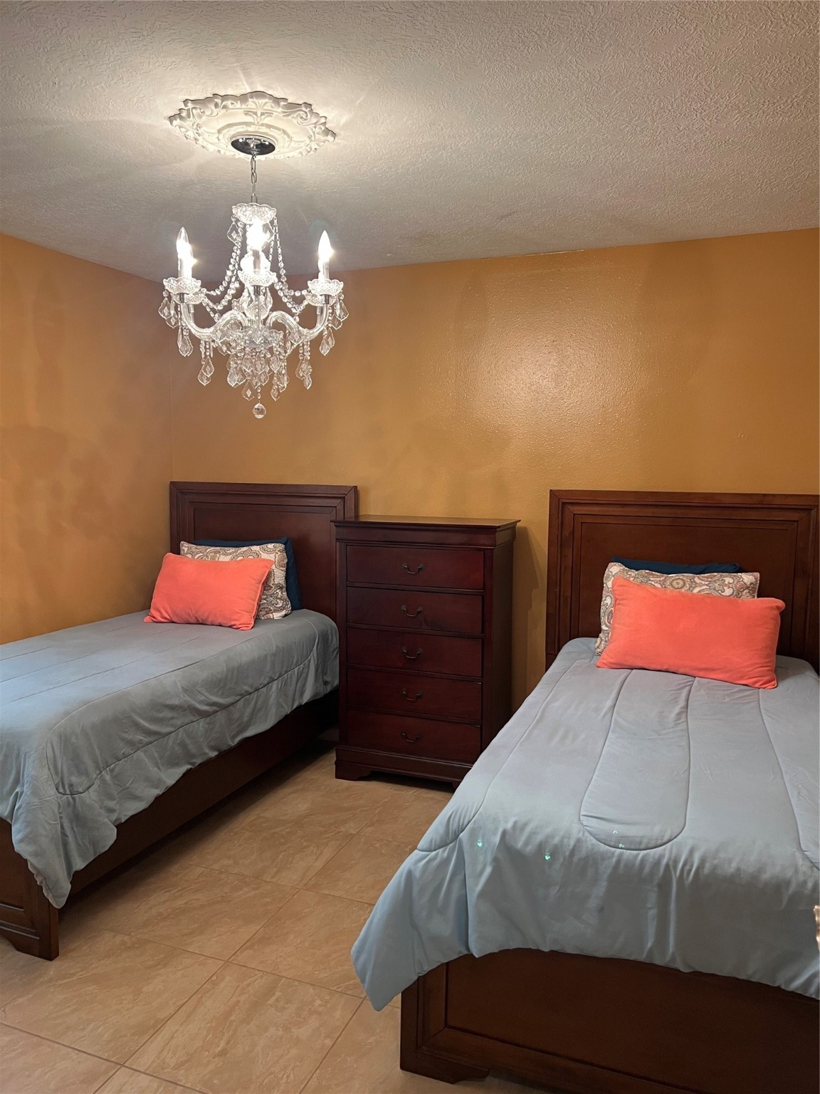 22814 Tree House Lane Spring, TX 77373 - Photo 8 of 11 a bedroom with a bed and a chandelier