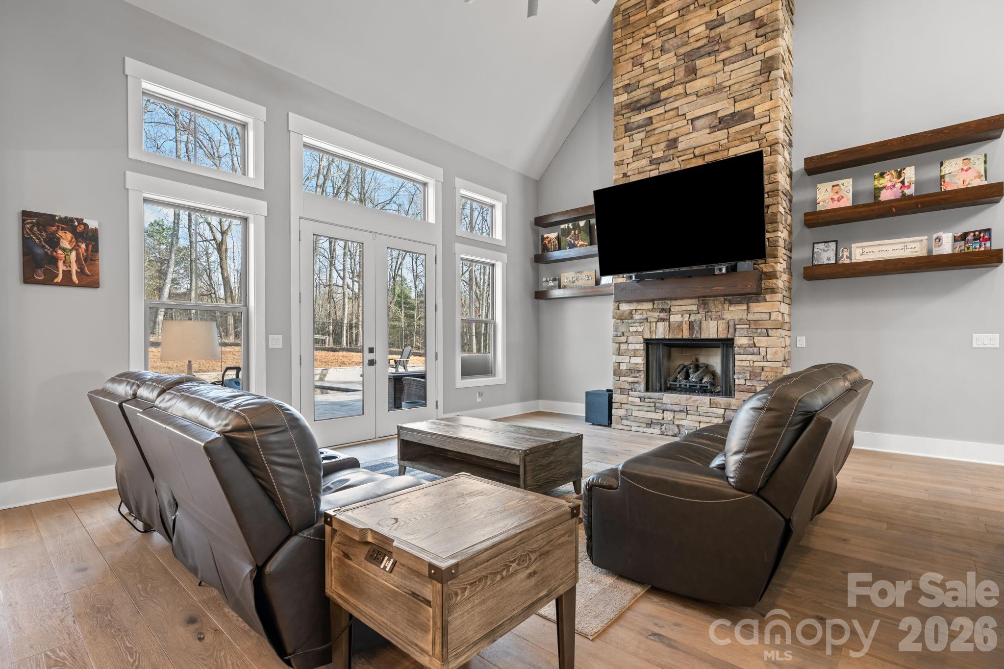 7269 Savannah Denver, NC 28037 - Photo 12 of 48 a living room with furniture a flat screen tv and a fireplace