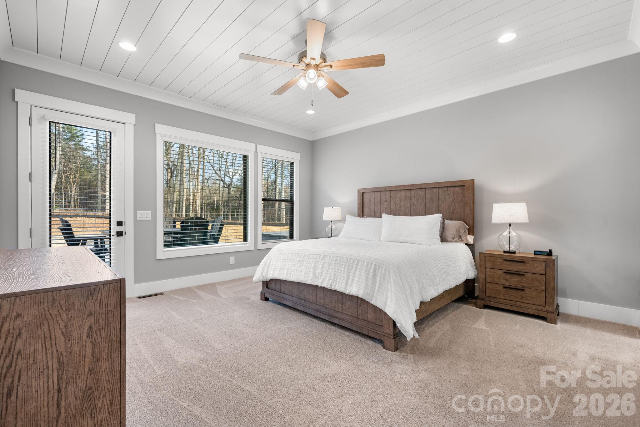 7269 Savannah Denver, NC 28037 - Photo 14 of 48 a spacious bedroom with a large bed and a chandelier