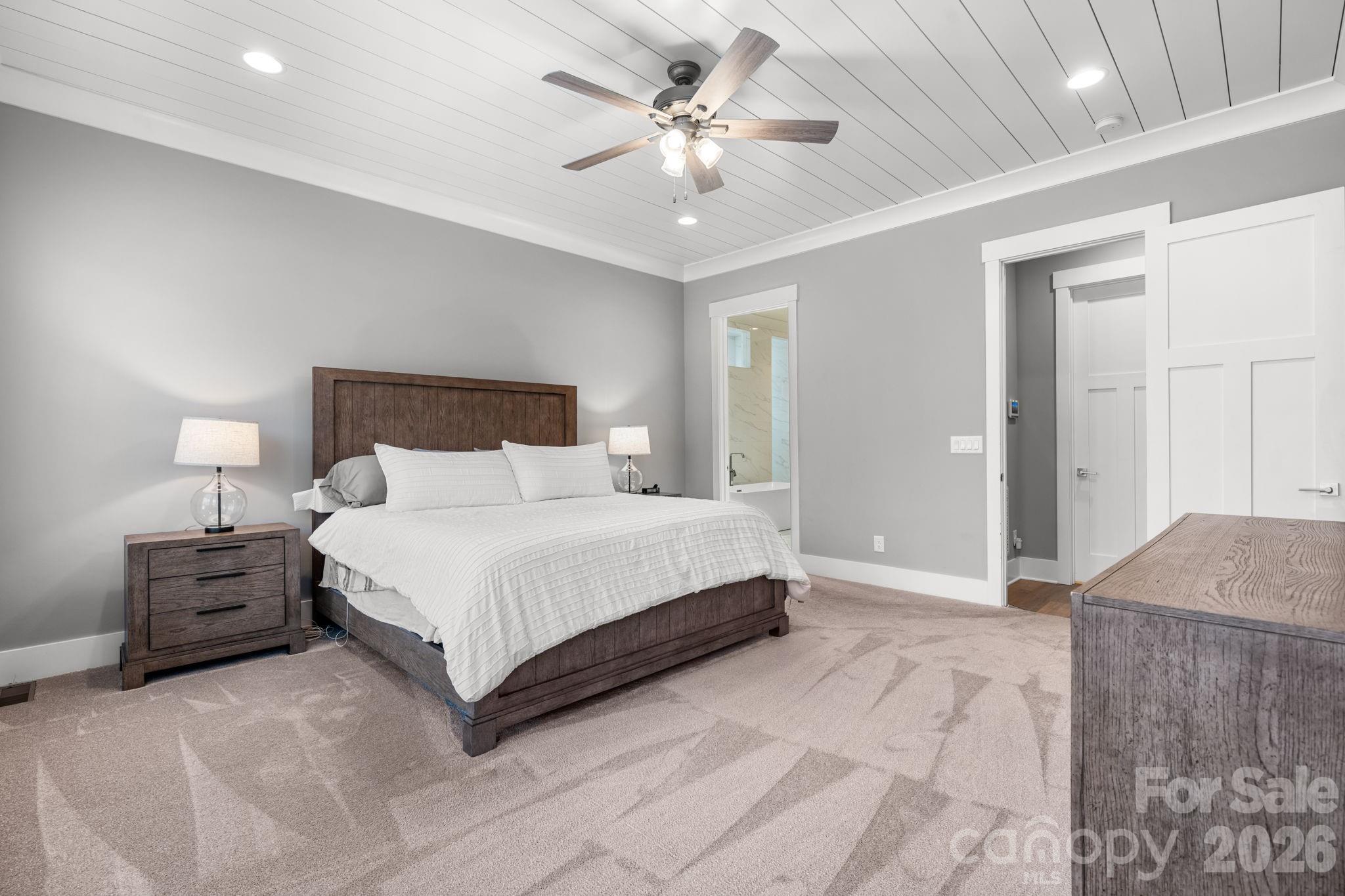 7269 Savannah Denver, NC 28037 - Photo 15 of 48 a bedroom with a large bed and ceiling fan