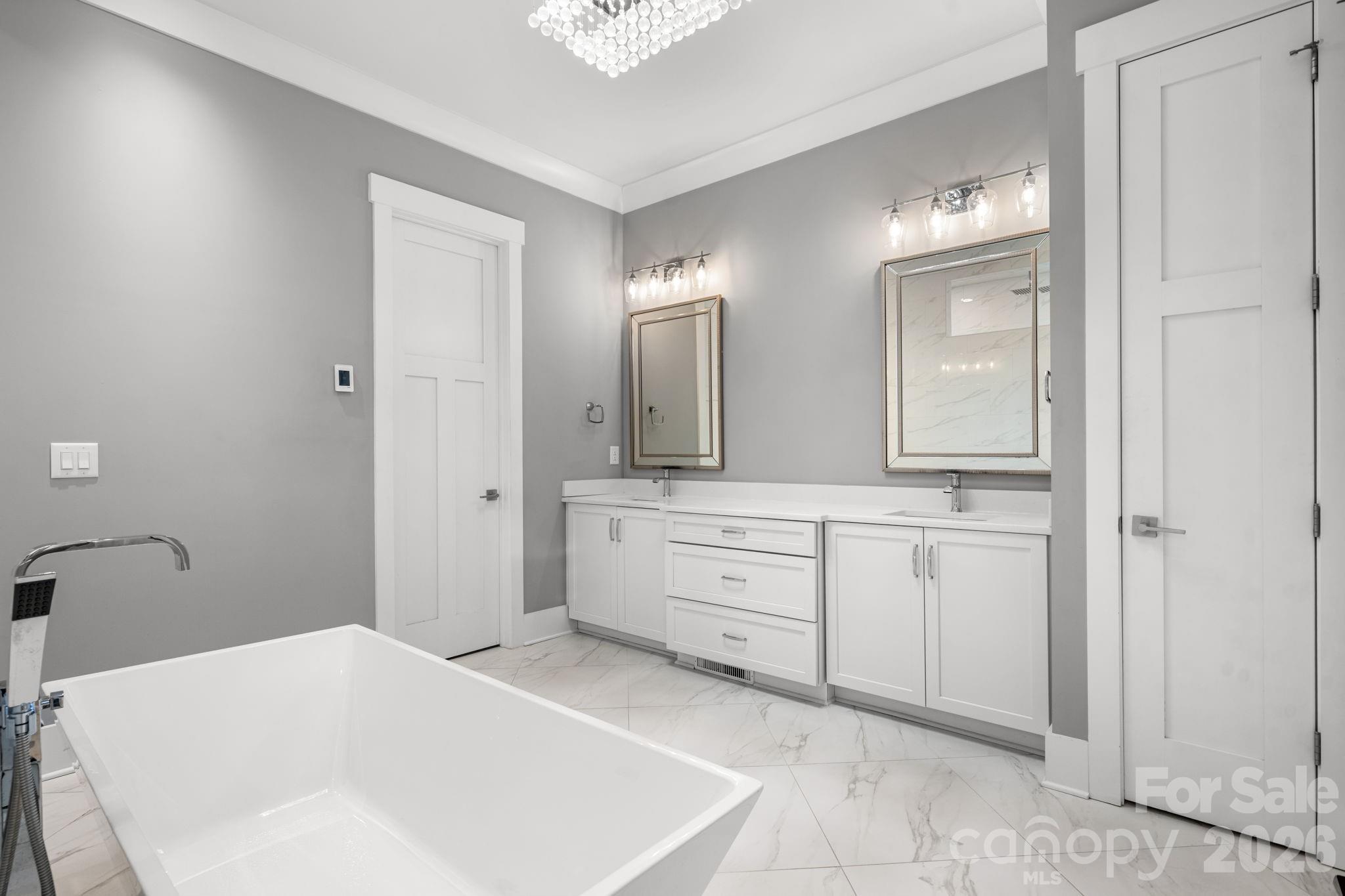 7269 Savannah Denver, NC 28037 - Photo 16 of 48 a spacious bathroom with a tub sink and mirror