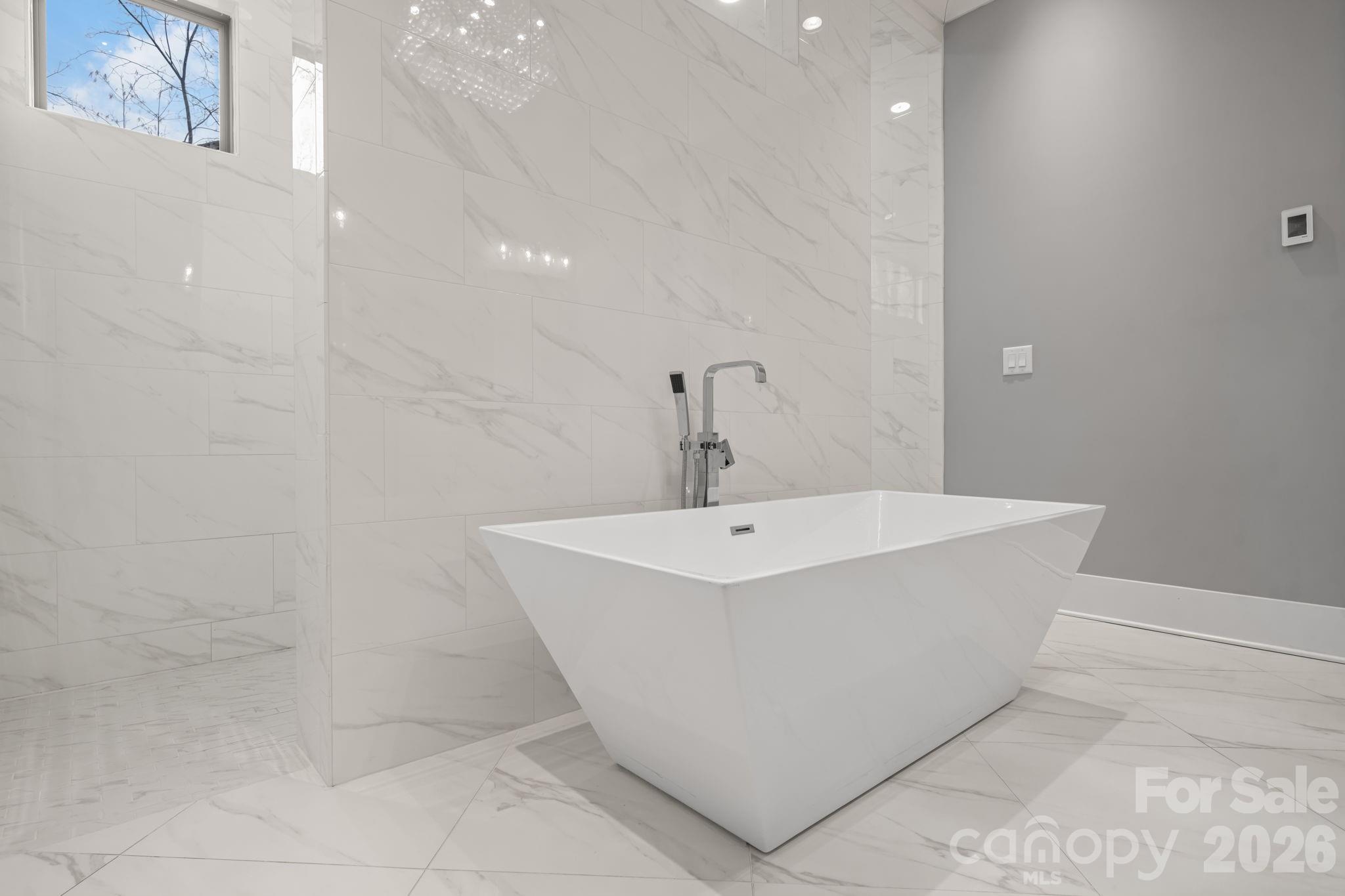 7269 Savannah Denver, NC 28037 - Photo 17 of 48 a white bath tub sitting in a bathroom