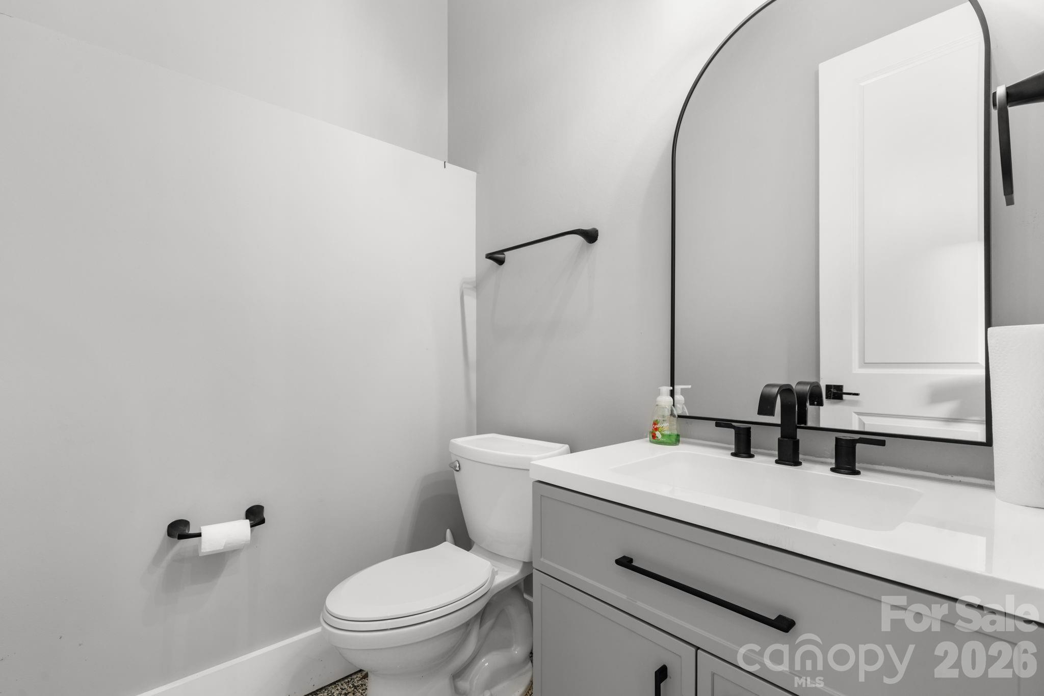 7269 Savannah Denver, NC 28037 - Photo 25 of 48 a bathroom with a granite countertop toilet a sink and a mirror