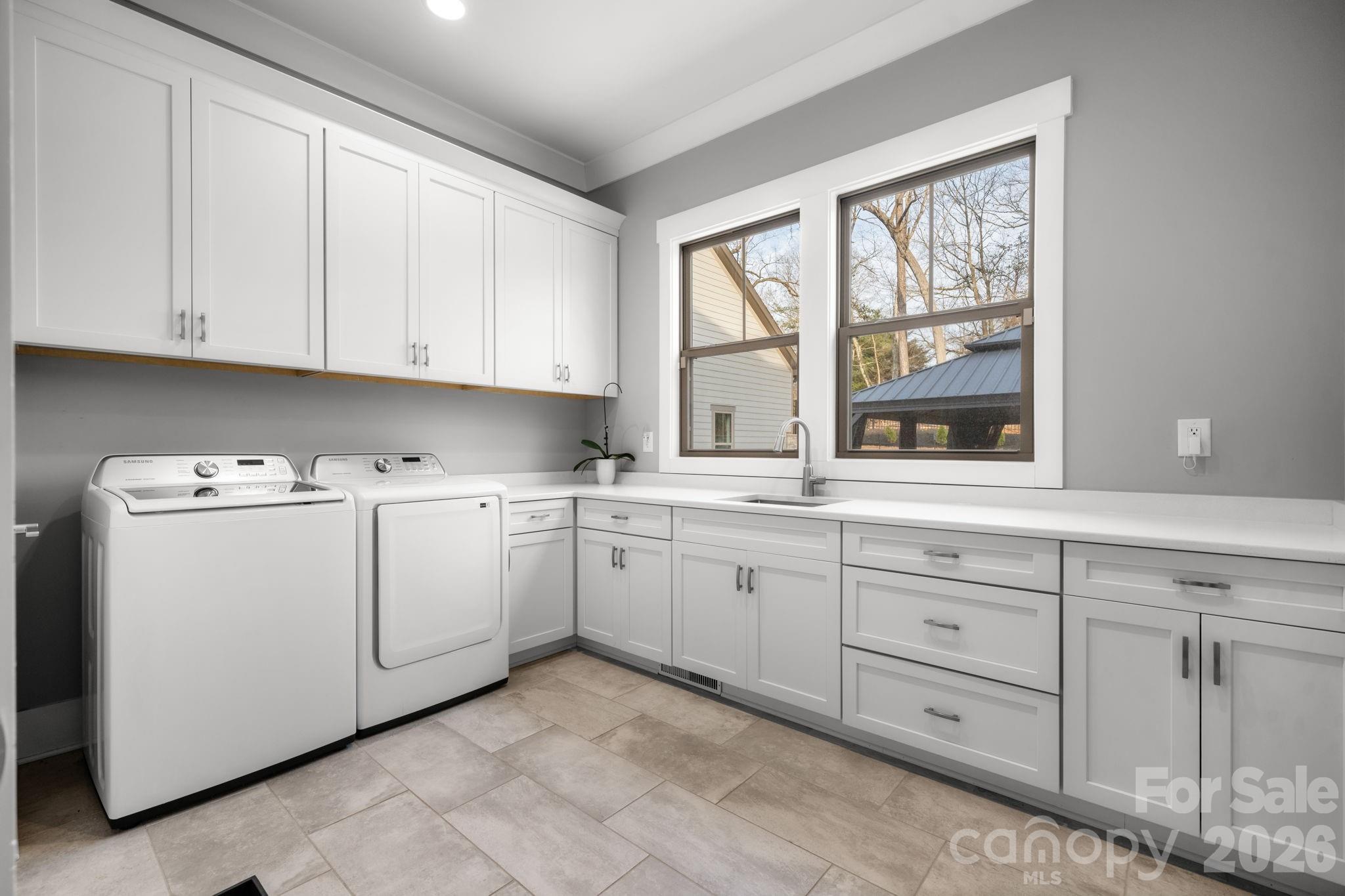 7269 Savannah Denver, NC 28037 - Photo 26 of 48 a utility room with cabinets washer and dryer