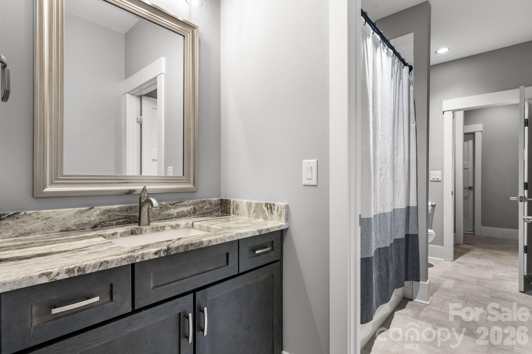 7269 Savannah Denver, NC 28037 - Photo 31 of 48 a bathroom with a granite countertop sink and a mirror