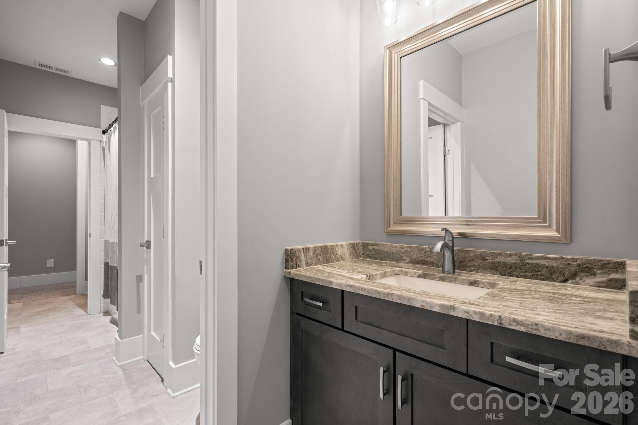 7269 Savannah Denver, NC 28037 - Photo 33 of 48 a bathroom with a granite countertop sink and a mirror