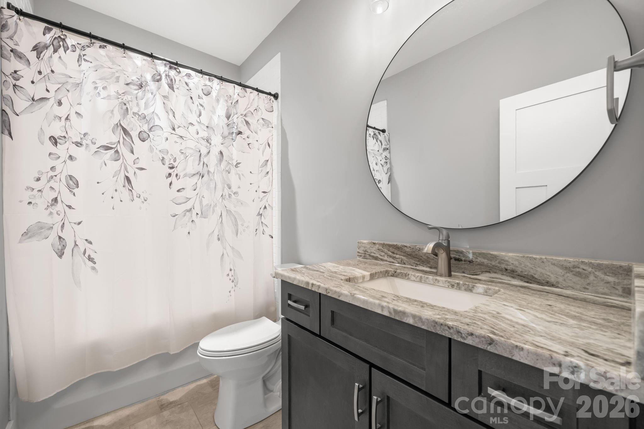 7269 Savannah Denver, NC 28037 - Photo 34 of 48 a bathroom with a granite countertop sink toilet and mirror