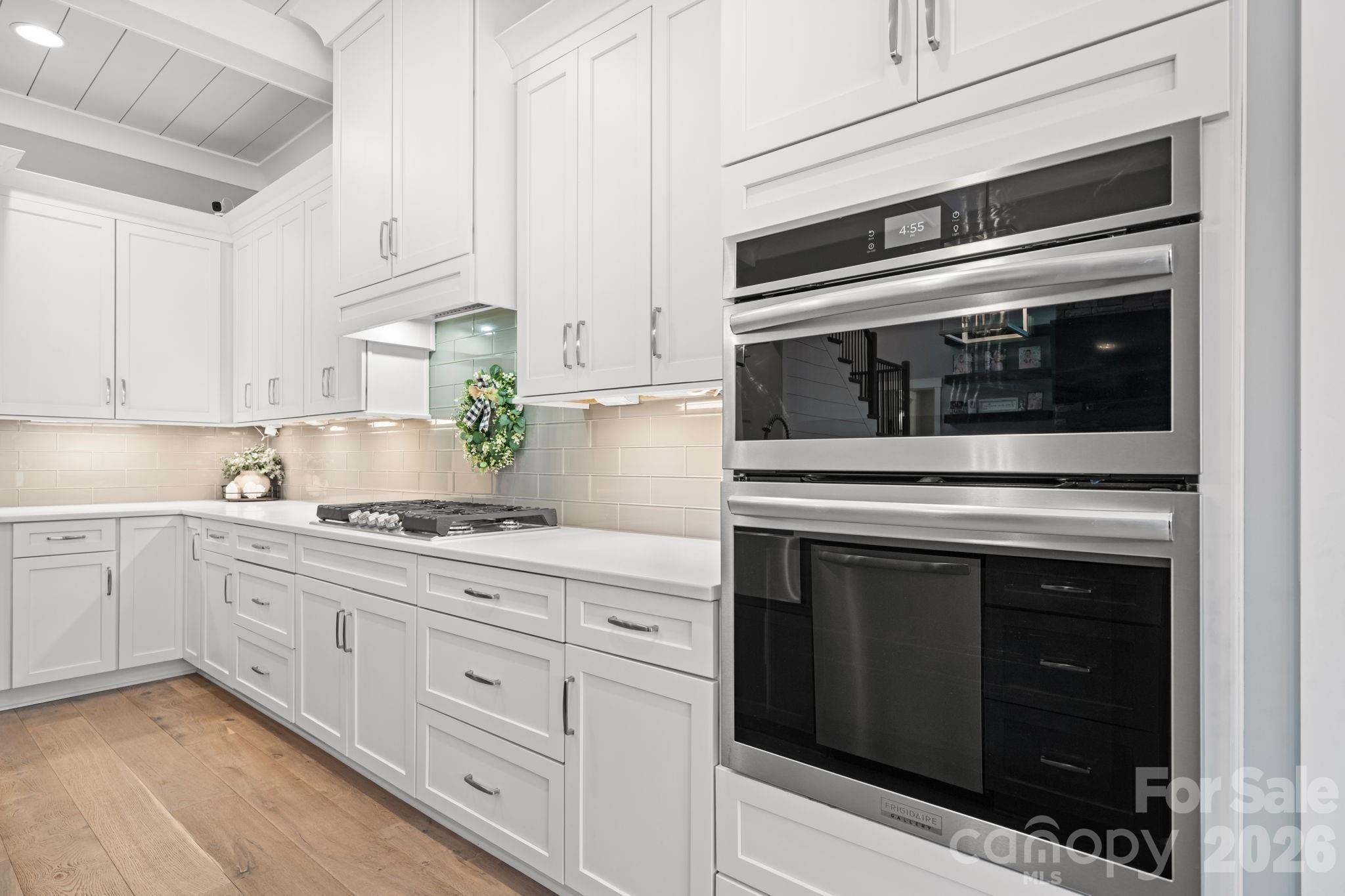7269 Savannah Denver, NC 28037 - Photo 6 of 48 a kitchen with stainless steel appliances white cabinets and a stove top oven