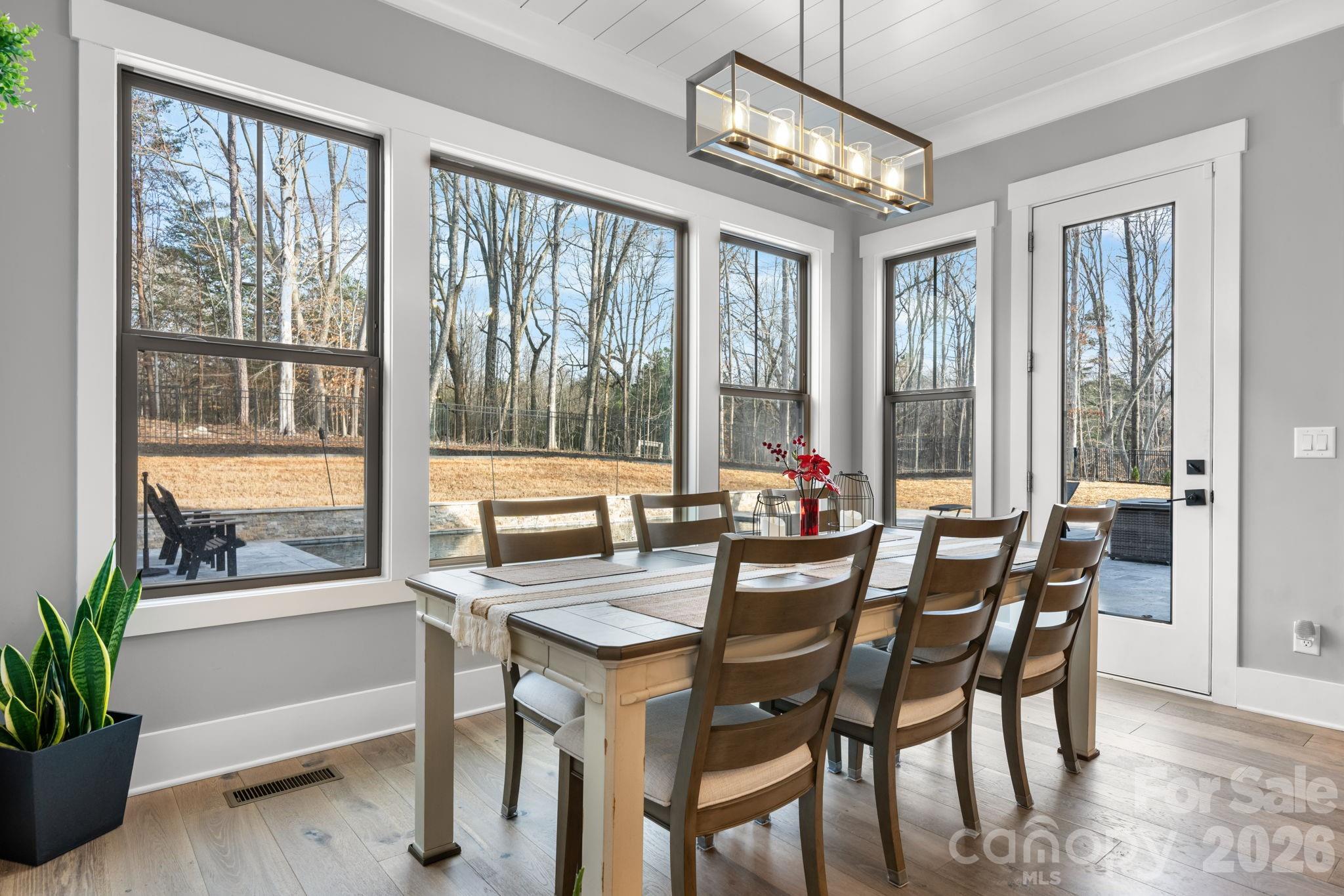 7269 Savannah Denver, NC 28037 - Photo 10 of 48 a view of a dining room with furniture large windows and wooden floor