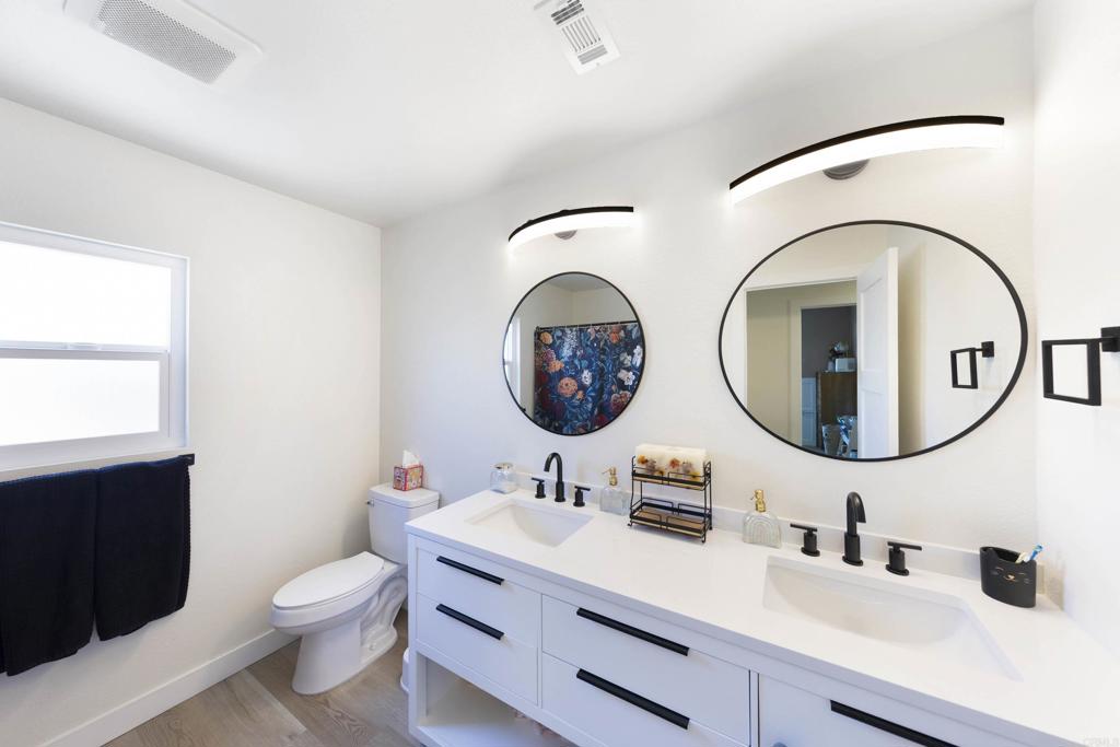 3577 Winslow Road Oceanside, CA 92056 - Photo 29 of 53 a bathroom with a toilet a sink and a mirror