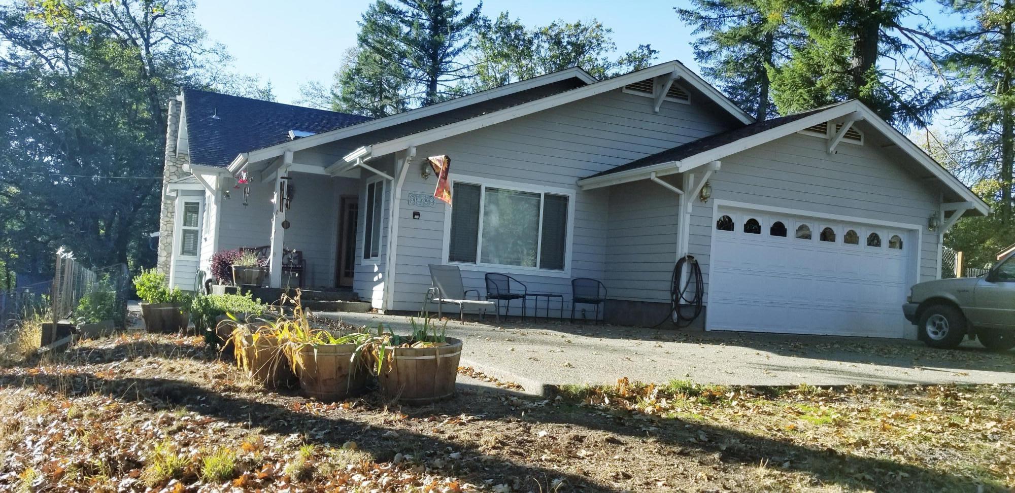 975 Waldo Road O'Brien, OR 97534 - Photo 1 of 27 FRONT VIEW OF HOME. THE SELLER ADDED ADDITIONAL EXPOSED AGGREGATE ON THE DRIVEWAY