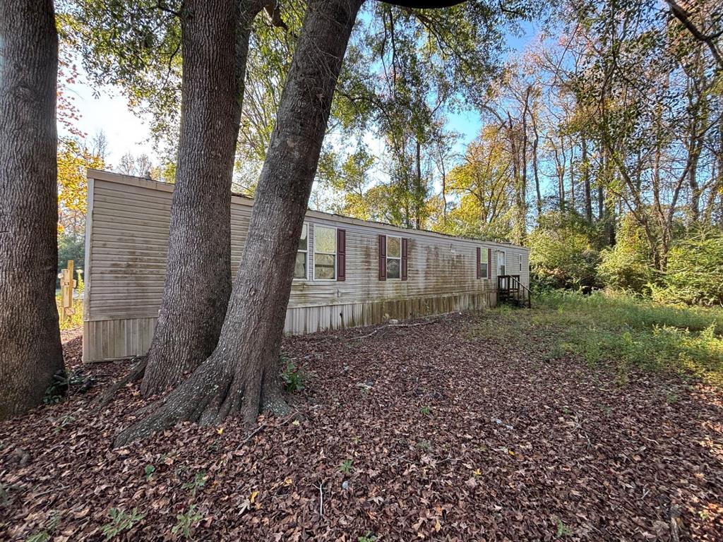 1233 Suncrest Circle Jasper, TX 75951 - Photo 3 of 15 a view of a house with a yard and tree s