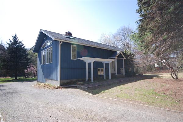 9 Alpine Road Wayland, MA 01778 - Photo 13 of 16 a front view of a house with a yard and garage